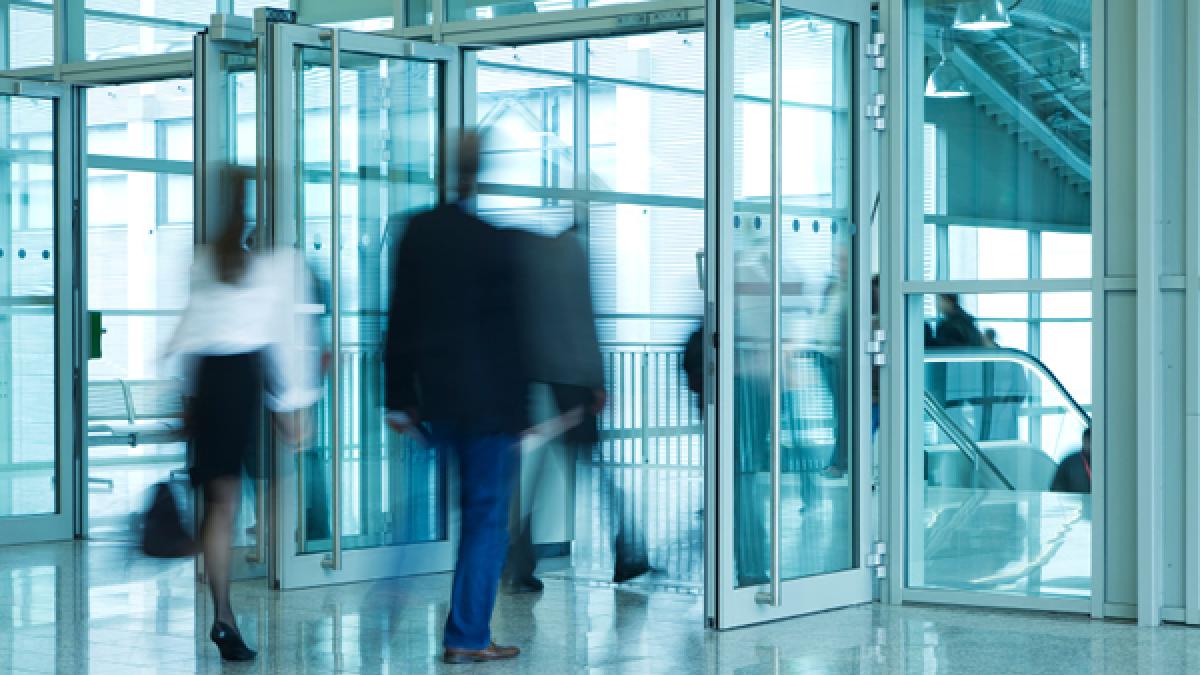 People Walking Through Entrance Door