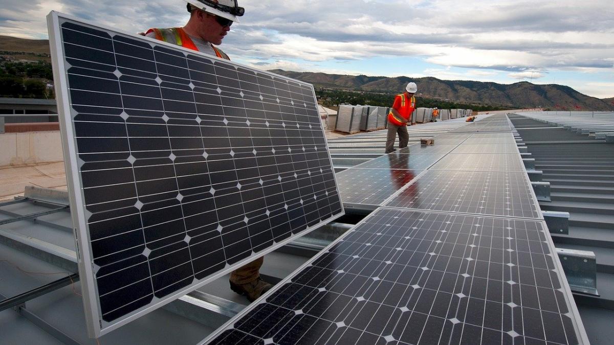 Workers installing solar panels