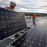Workers installing solar panels