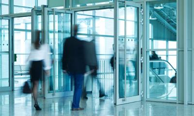 People Walking Through Entrance Door