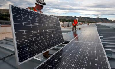 Workers installing solar panels